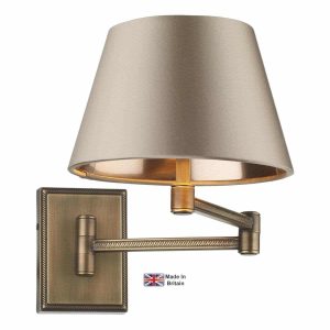 Pimlico swing arm wall light in solid antique brass on white background lit