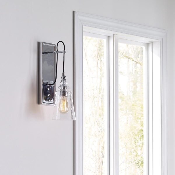 Quintiesse Loras polished chrome single wall light with seeded glass shade mounted alongside window