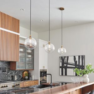 Quintiesse Skye contemporary 1 light designer pendant in heritage brass over kitchen island