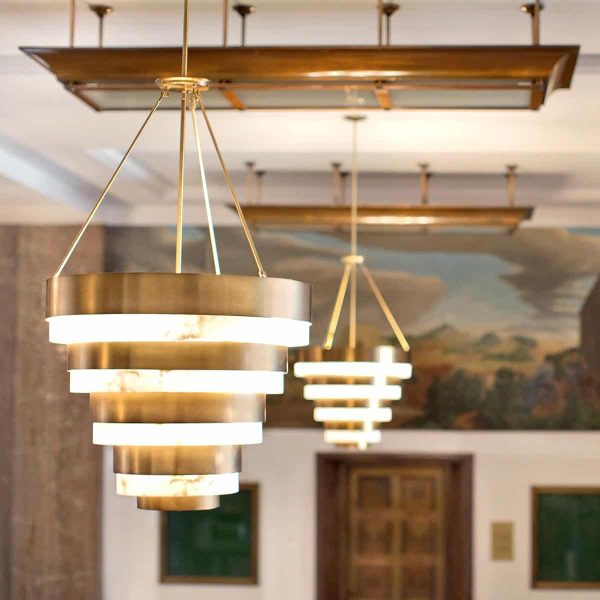 Quintiesse Echelon Art Deco style 8 light chandelier in heritage brass fitted in lounge