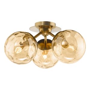 Ulrika 3 arm flush ceiling light in antique brass with amber glass on white background lit