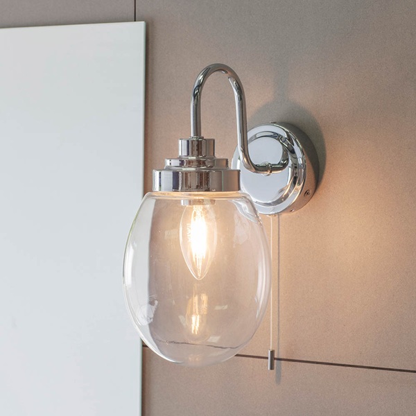 Hampton bathroom wall light with pull cord switch in polished chrome with clear glass.